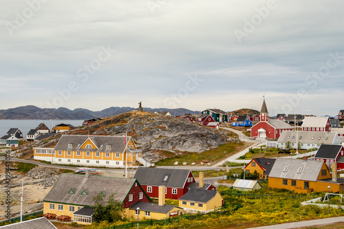 Colorful houses with the school Det gamle Sygehus, the cathedral and the statue of Hans Egede in the background, Nuuk, Greenland. photo