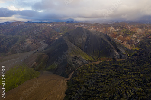 Iceland in september 2019. Great Valley Park Landmannalaugar, surrounded by mountains of rhyolite and unmelted snow. In the valley built large camp. The concept of world tours. Aerial drone shot. photo