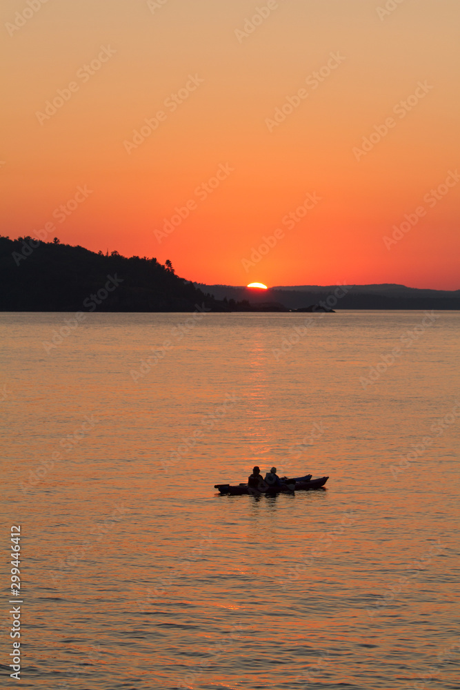 Silhouette of two kayakers at sunset on Lake Superior
