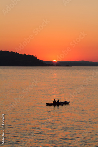 Silhouette of two kayakers at sunset on Lake Superior