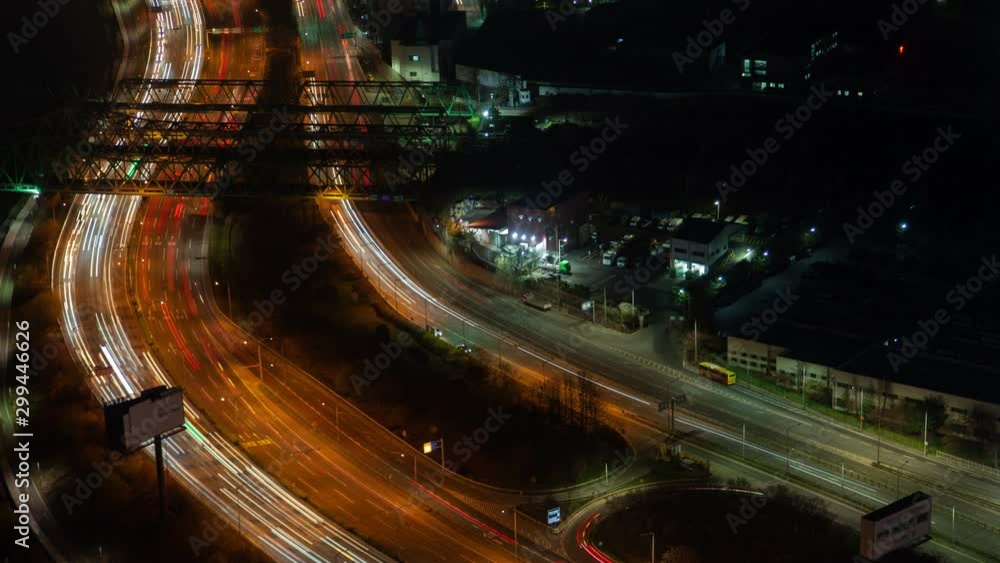 Timelapse modern Seoul wide highway with driving cars in heavy night traffic surrounded by trees and small buildings pan up Timelapse modern Seoul wide highway with driving cars in heavy night traffic surrounded by trees and small buildings pan up