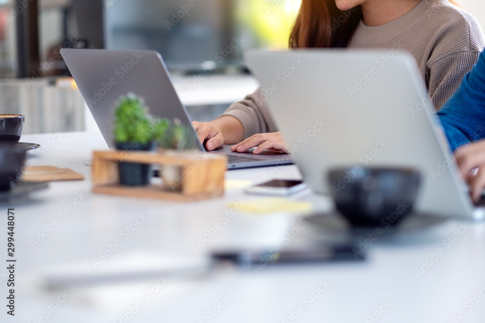 Fototapeta premium Closeup image of businessman using and working on laptop computer together in office