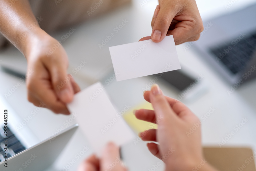 Two businessman holding and exchanging empty business card Two businessman holding and exchanging empty business card