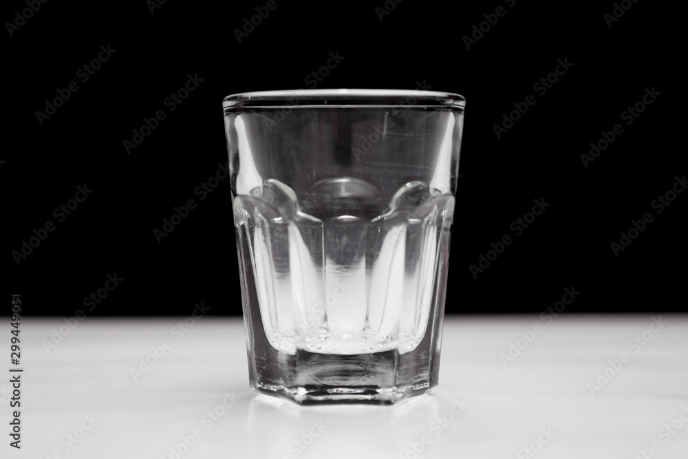 Shot glass on white and black background Shot glass on white and black background