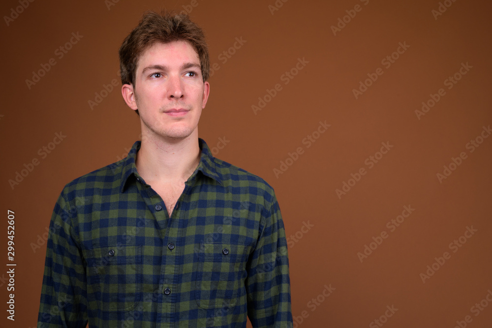 Face of young handsome hipster man in green checkered shirt Face of young handsome hipster man in green checkered shirt