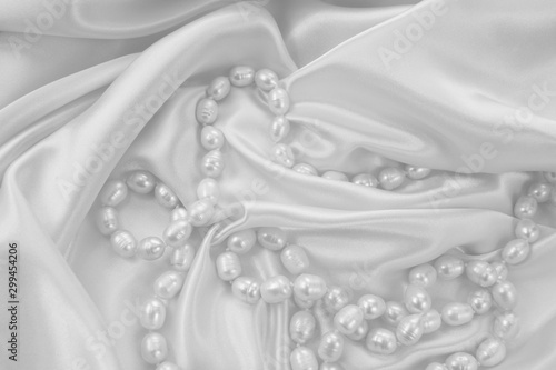 Delicate white satin draped...