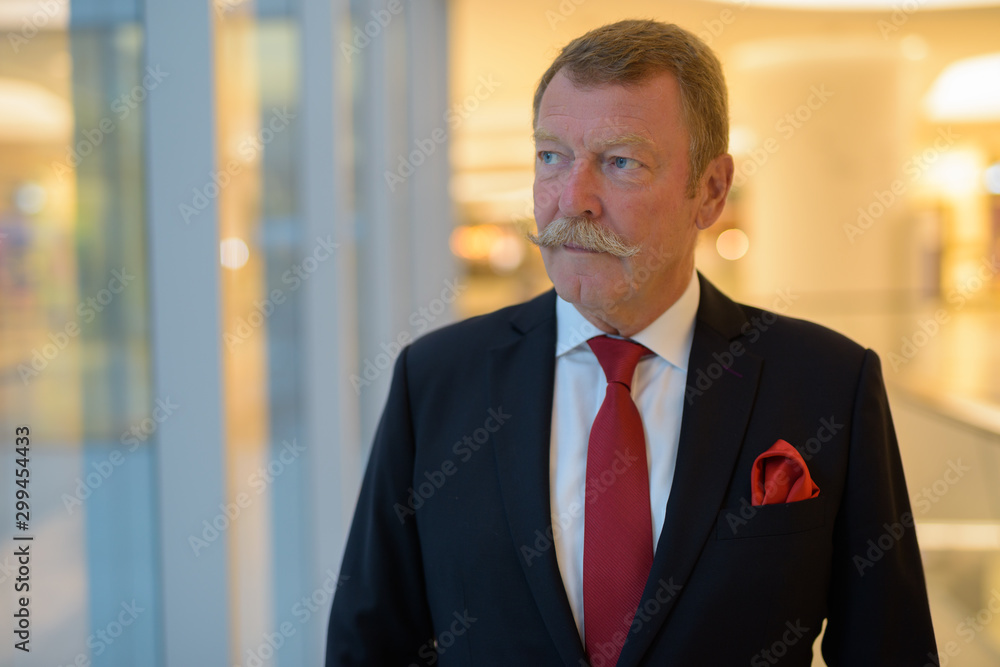 Handsome senior businessman with mustache exploring the city Handsome senior businessman with mustache exploring the city
