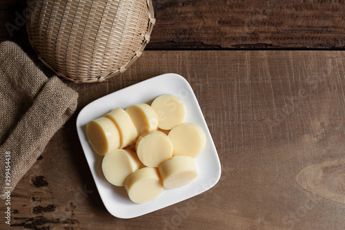 sliced of egg tofu in a ceramic dish on wooden table prepare to cook, top view. healthy food concept.