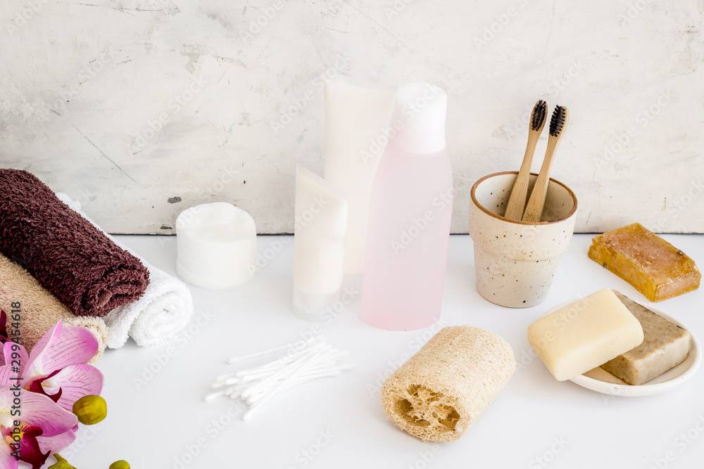 Bathroom accessories set with tooth brushes and towels on white background Bathroom accessories set with tooth brushes and towels on white background