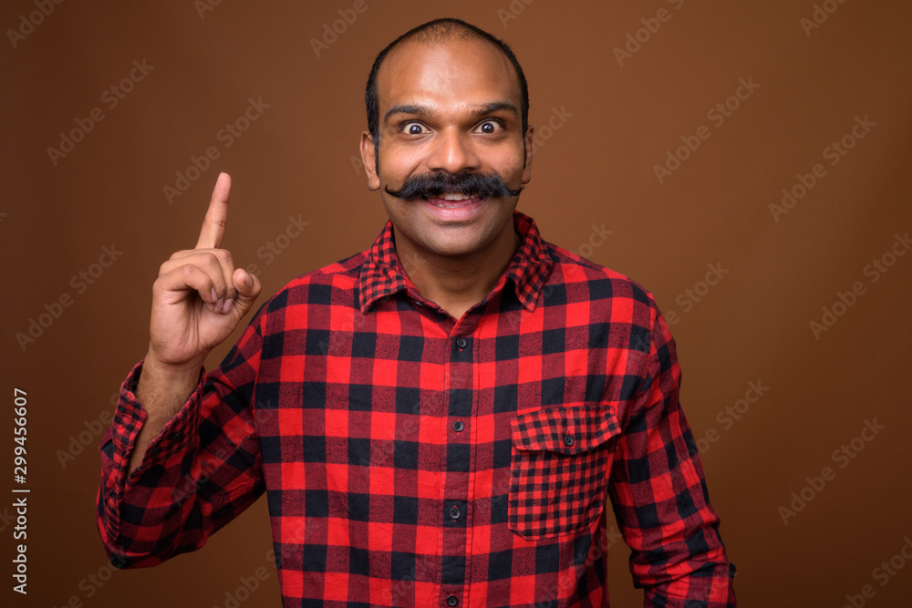 Portrait of happy Indian hipster man with mustache Portrait of happy Indian hipster man with mustache