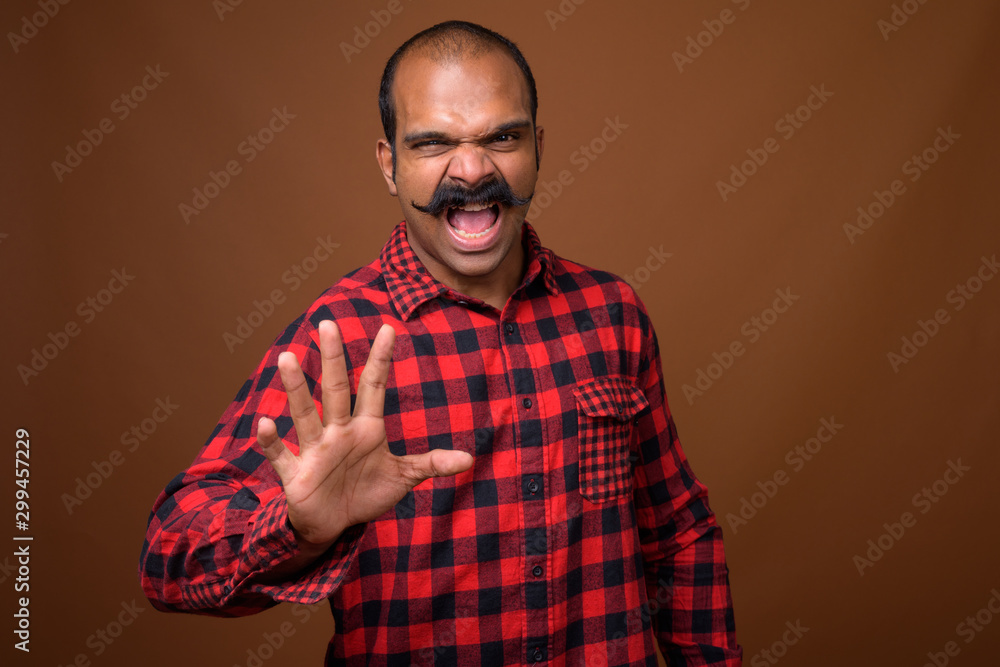 Fototapeta premium Portrait of Indian hipster man with mustache