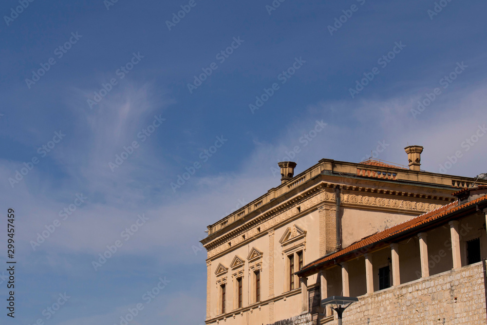 The building in the old town on the background of blue sky. Cator. Old town. Montenegro.