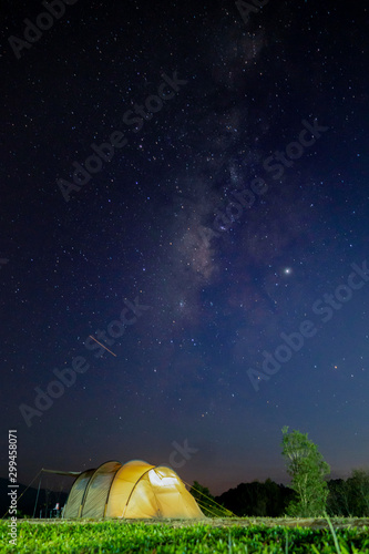 The growing tent with the milky way in the night sky background
