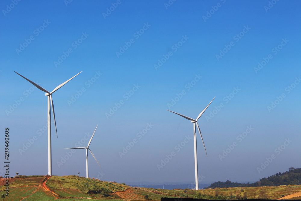 Wind mill turbine on the top of mountain in blue sky, the natural generator energy. From petchaboon Wind mill turbine on the top of mountain in blue sky, the natural generator energy. From petchaboon