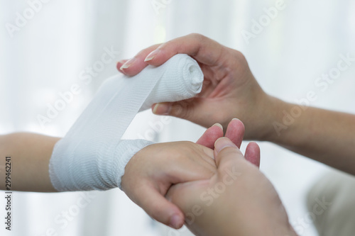 Valokuvatapetti Child hand with gauze bandage on it.