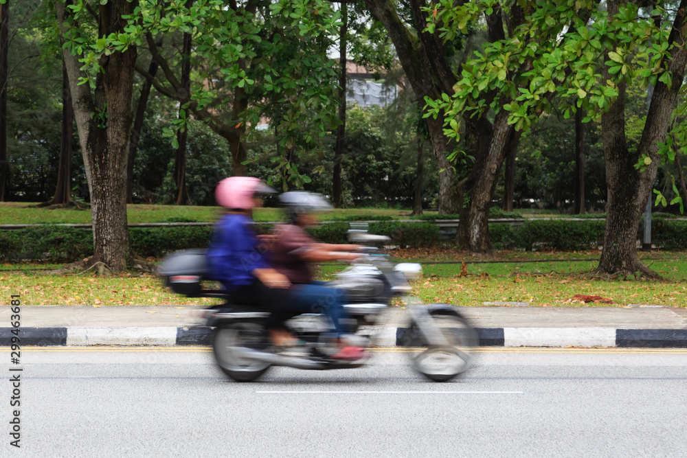 motorbike rider on the city forest roadway motion blur view motorbike rider on the city forest roadway motion blur view
