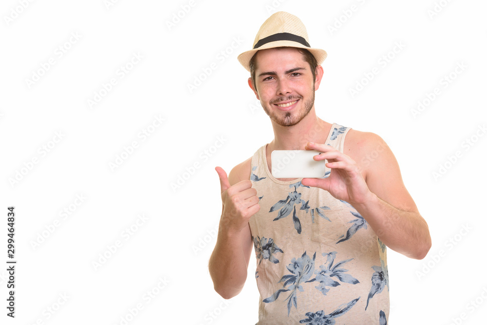 Happy young bearded tourist man taking picture with phone ready for vacation Happy young bearded tourist man taking picture with phone ready for vacation