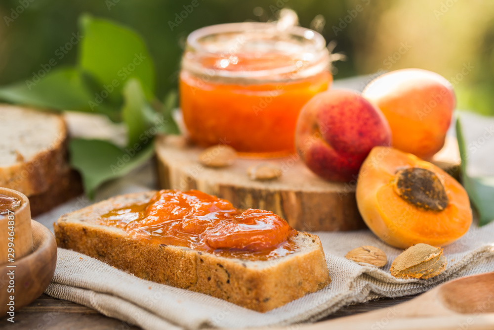 Apricot jam and ripe apricots on the wooden natural table. Apricot jam and ripe apricots on the wooden natural table.