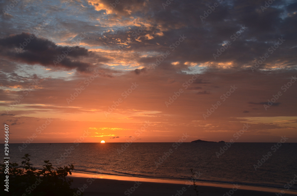 Orange cloudy tropical sunrise seascape, Thailand.
