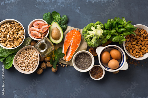 Health food fitness. Food sources of omega 3 on dark background top view. Foods high in fatty acids including vegetables, seafood, nut and seeds photo