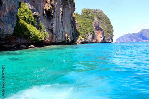 boat ride on the sea, exotic James Bond islands against the blue sea, waves of spray in Thailand