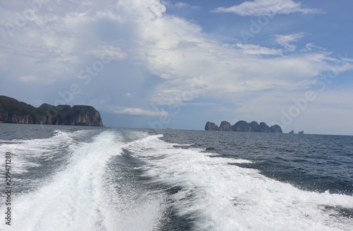 boat ride on the sea, exotic James Bond islands against the blue sea, waves of spray in Thailand