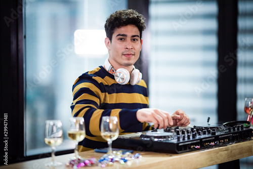 Male DJ playing music in party