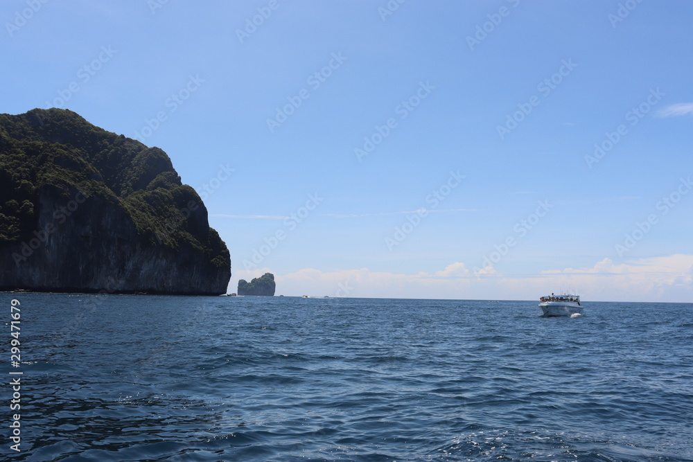 boat ride on the sea, exotic James Bond islands against the blue sea, waves of spray in Thailand boat ride on the sea, exotic James Bond islands against the blue sea, waves of spray in Thailand