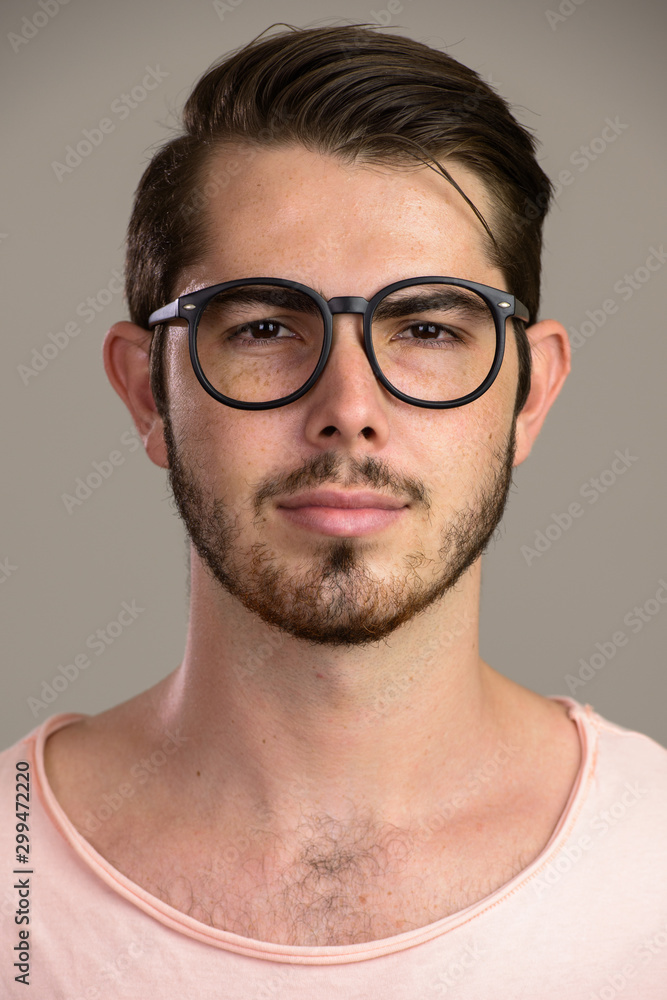 Face of young handsome bearded man looking at camera Face of young handsome bearded man looking at camera