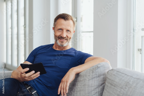 Relaxed attractive middle-aged man on a sofa