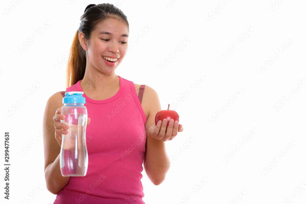 Studio shot of young Asian woman ready for gym Studio shot of young Asian woman ready for gym