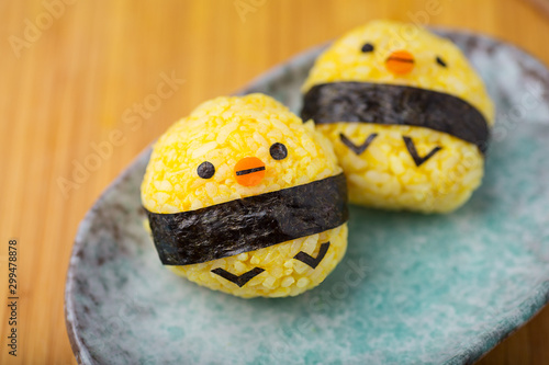 Cute rice balls on wooden background
