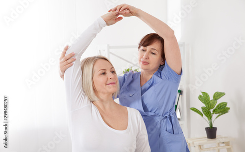 Physiotherapy  sport injury rehabilitation treatment. Woman having chiropractic back adjustment. Osteopathy  Alternative medicine  pain relief concept.