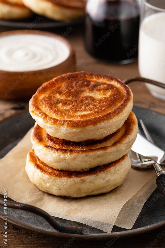 Homemade pancakes stack with milk and jam on wooden background. Homemade pancakes stack with milk and jam on wooden background.