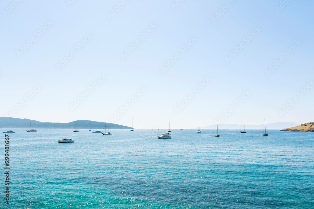 Fototapeta premium Nice view of the sea. Sunny bright day yachts are anchored in the bay. Aegean Sea Bodrum Turkey.