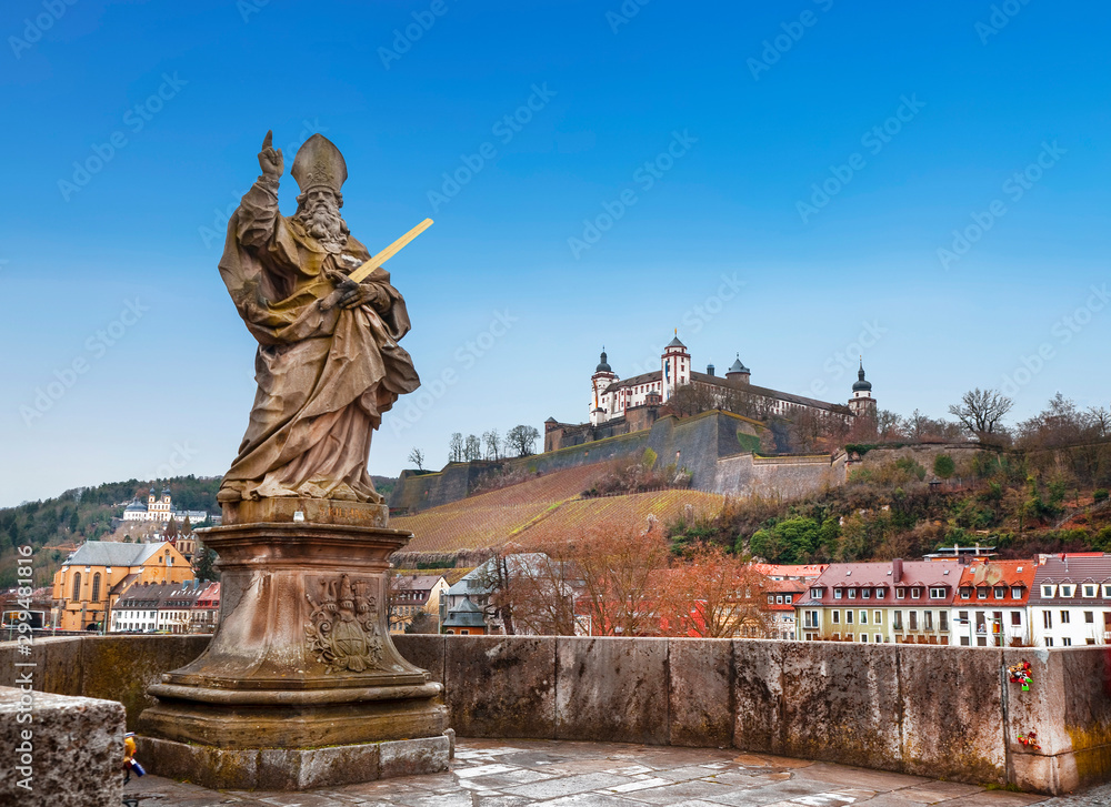 View of the city of Wurzburg, the old Alta Mainbrucke bridge with the sculpture of St. Kilian and the fortress of Marienberg. Bavaria, Germany