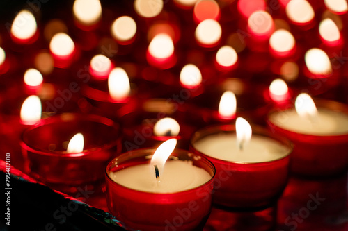 Red burning candles selective focus and bokeh. Symbol of sadness and sorrow. Copy space.