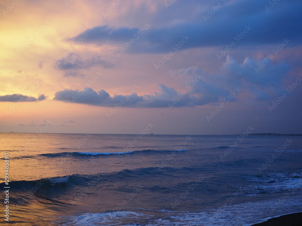 Red sunset over the sea, rich in dark clouds, rays of light