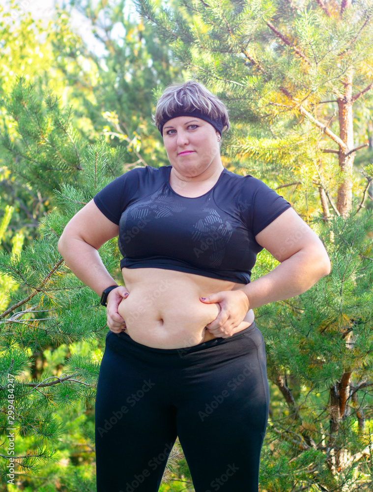 Fat girl wants to lose weight. An obese woman does sports. The girl with  excess weight. Stock Photo