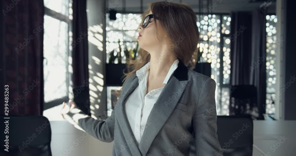 Young tired woman in business suit throwing papers, undoing hair and going fun, releasing stress Young tired woman in business suit throwing papers, undoing hair and going fun, releasing stress