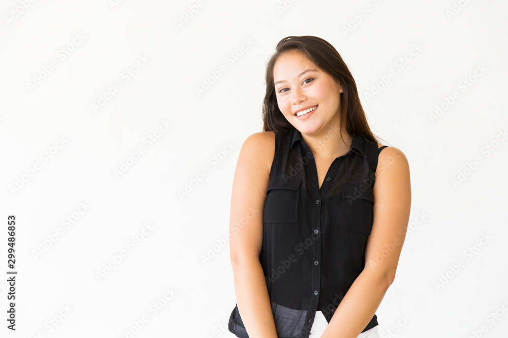 Portrait of cheerful shy dark haired teenage girl in casual. Young Latin woman in casual standing isolated over white background. Female portrait concept Portrait of cheerful shy dark haired teenage girl in casual. Young Latin woman in casual standing isolated over white background. Female portrait concept