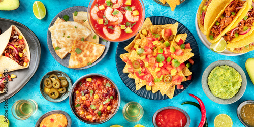 Wallpaper Mural Mexican food, panoramic overhead shot of the typical dishes like nachos, quesadillas, shrimp cocktail, chili con carne, taco shells, burrito wraps, with guacamole and tequila, a flatlay Torontodigital.ca