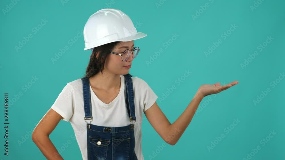 Asian engineer woman is working on a building project against a green screen. Asian engineer woman is working on a building project against a green screen.