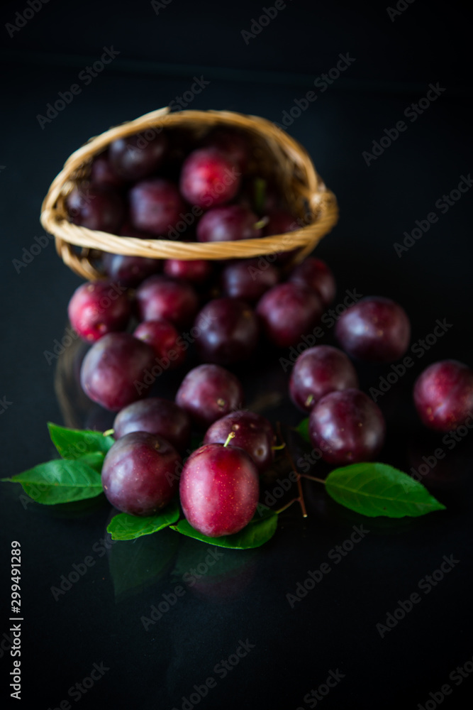 organic red ripe cherry plum isolated on black organic red ripe cherry plum isolated on black