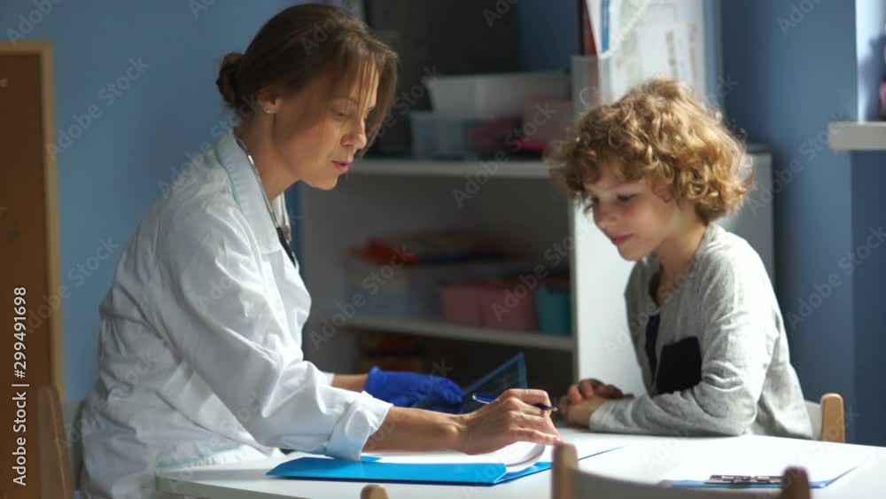 End of visit to the pediatrician. A female doctor gives recommendations for the treatment of curly teenagers. The boy thanks and leaves End of visit to the pediatrician. A female doctor gives recommendations for the treatment of curly teenagers. The boy thanks and leaves