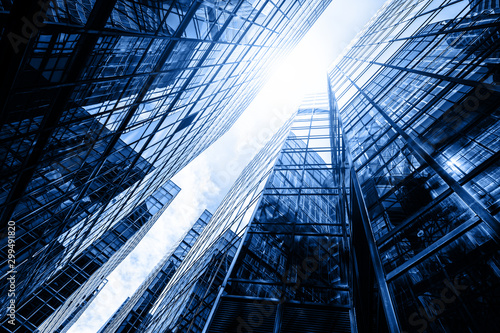 Canvas Print Skyscraper glass facades on a bright sunny day with sunbeams in the blue sky