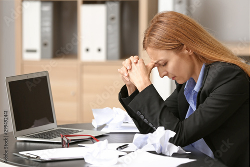 Stressed woman at workplace...