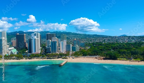 Drone aerial panorama view of Waikiki beach Honolulu Hawaii USA golden beaches turquoise beach lush green palms with hotels resorts in background 