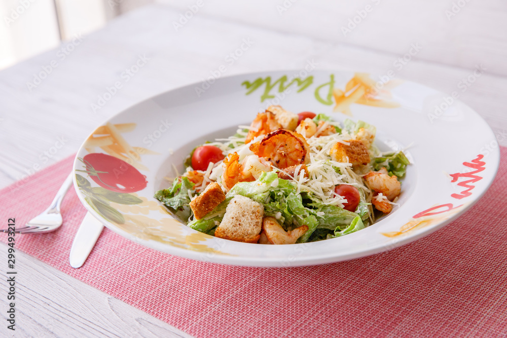 Caesar salad with seafood, the plate says pasta. Caesar salad with seafood, the plate says pasta.