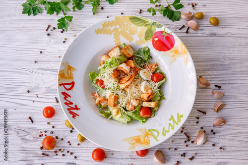 Caesar salad with seafood, the plate says pasta.